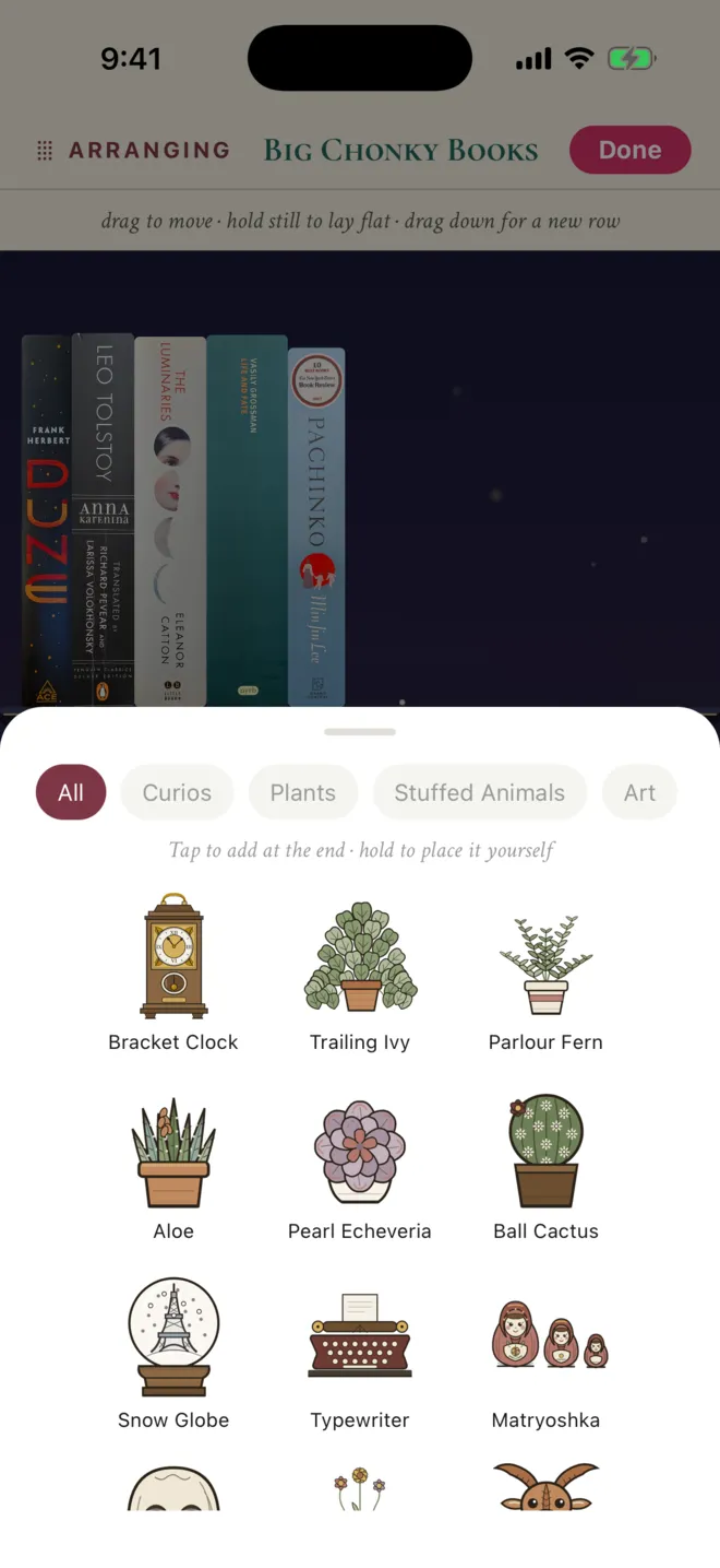 A decor bottom sheet with category filters and illustrated plants, a clock, a typewriter and framed art